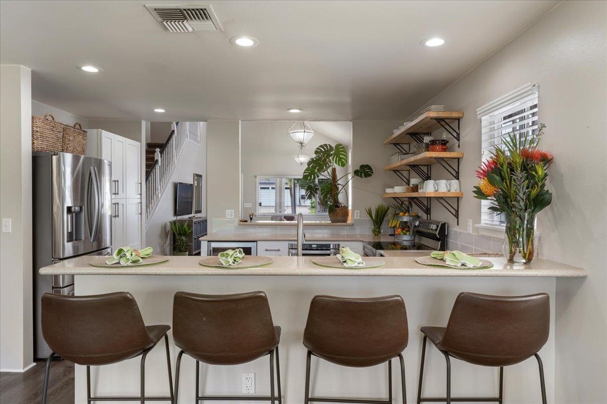 28 Papahi Loop Kahului, HI 96732 - Photo 17 of 50 a kitchen with stainless steel appliances kitchen island granite countertop a table and chairs in it
