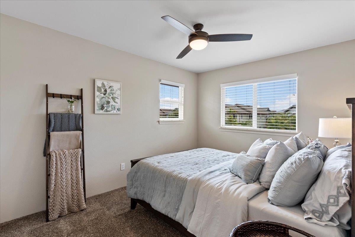 28 Papahi Loop Kahului, HI 96732 - Photo 40 of 50 a bedroom with a bed and a chandelier