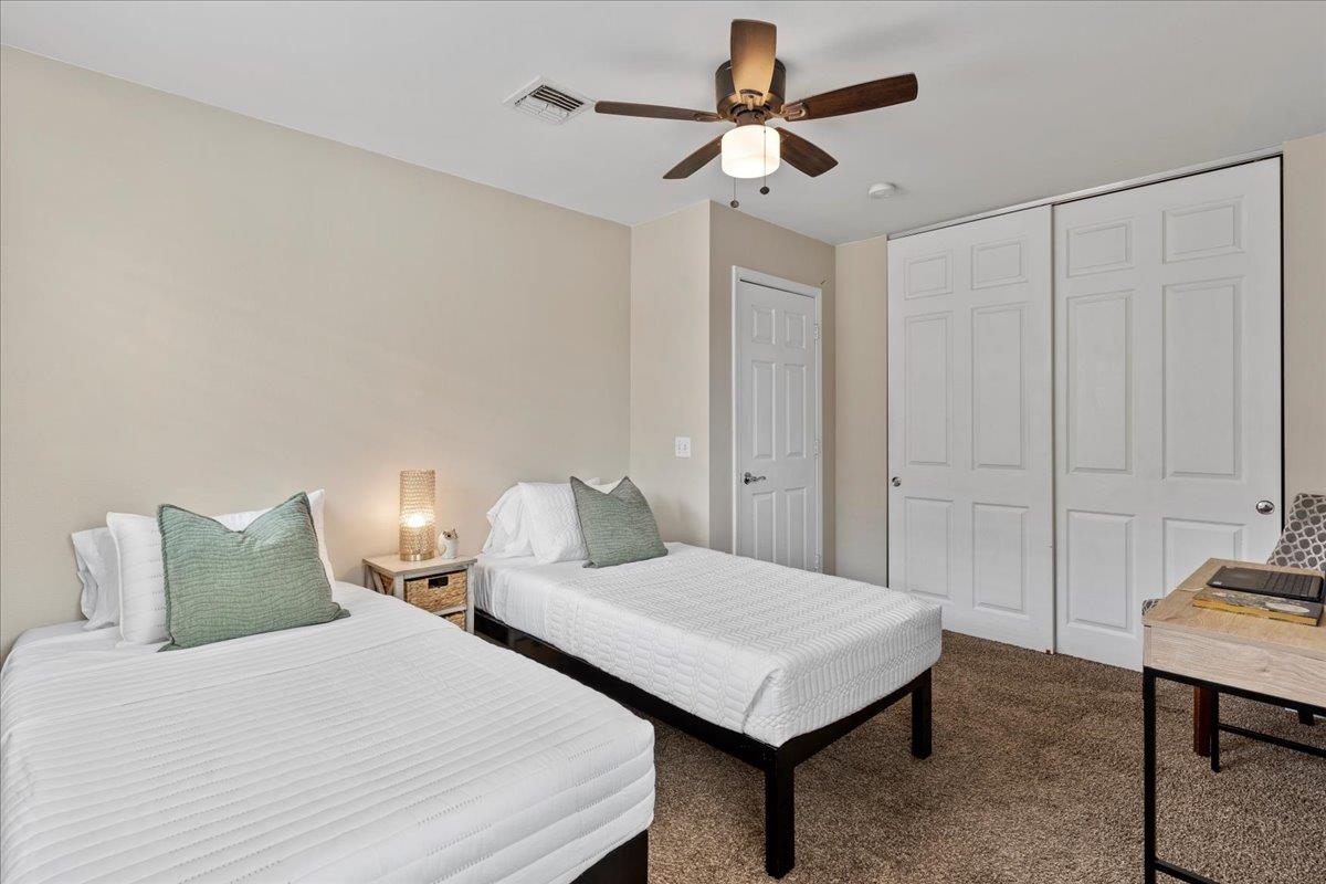 28 Papahi Loop Kahului, HI 96732 - Photo 42 of 50 a bedroom with a bed and a chandelier