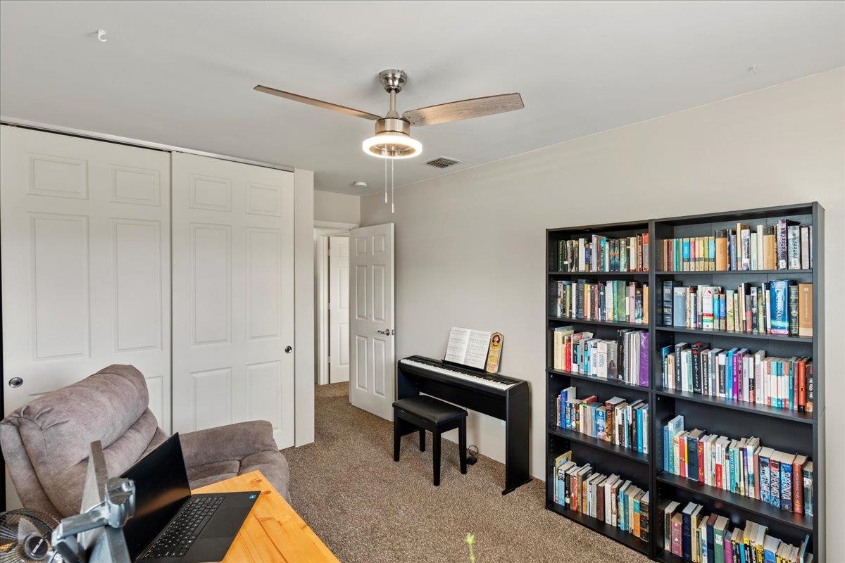 28 Papahi Loop Kahului, HI 96732 - Photo 46 of 50 a living room with furniture and a book shelf