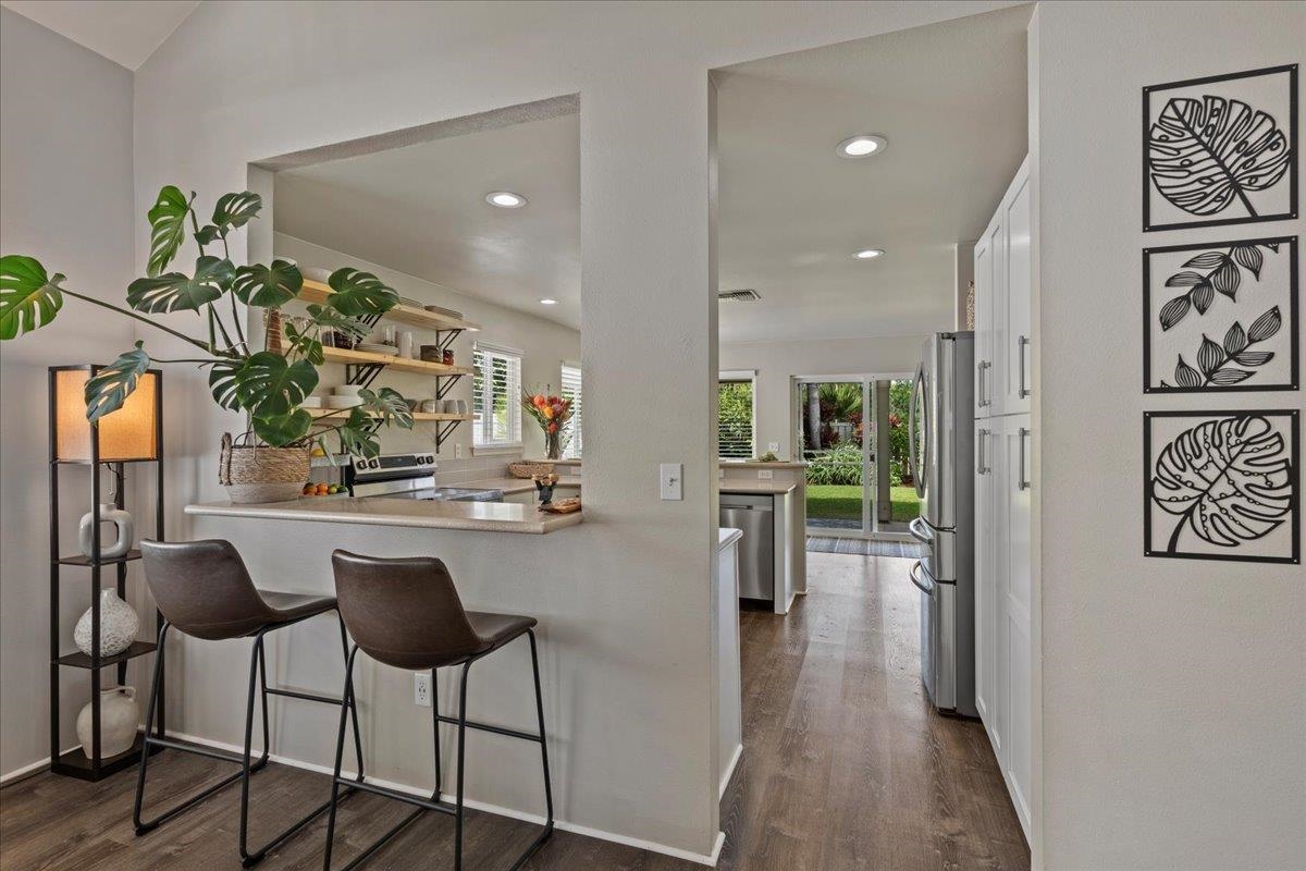 28 Papahi Loop Kahului, HI 96732 - Photo 10 of 50 a kitchen with stainless steel appliances kitchen island granite countertop a table and chairs in it
