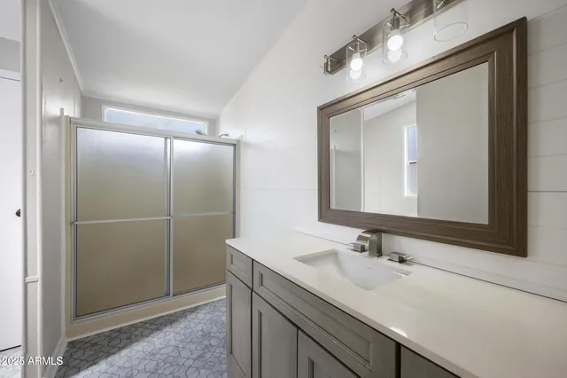 a bathroom with a sink double vanity granite and a mirror