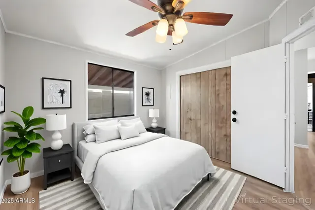 a bedroom with a large bed and a chandelier