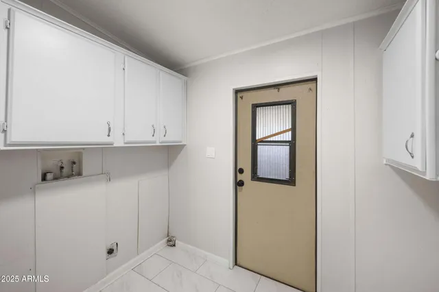 a kitchen with a refrigerator and cabinets