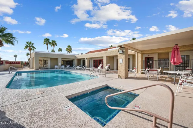 a view of house with swimming pool and furniture