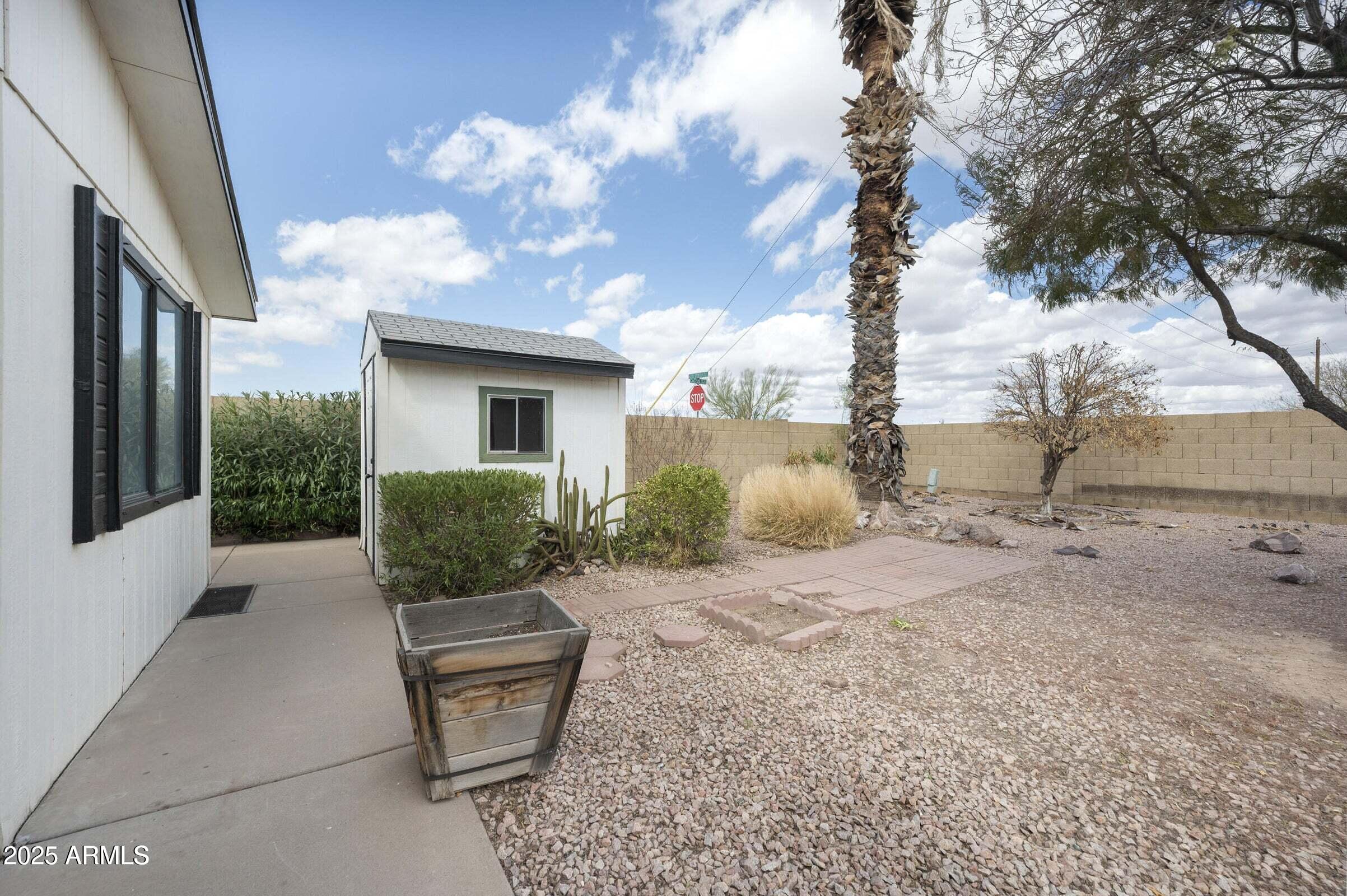 3500 South Tomahawk Road, Unit 126 Apache Junction, AZ 85119 - Photo 10 of 38 a view of a backyard with plants and outdoor seating