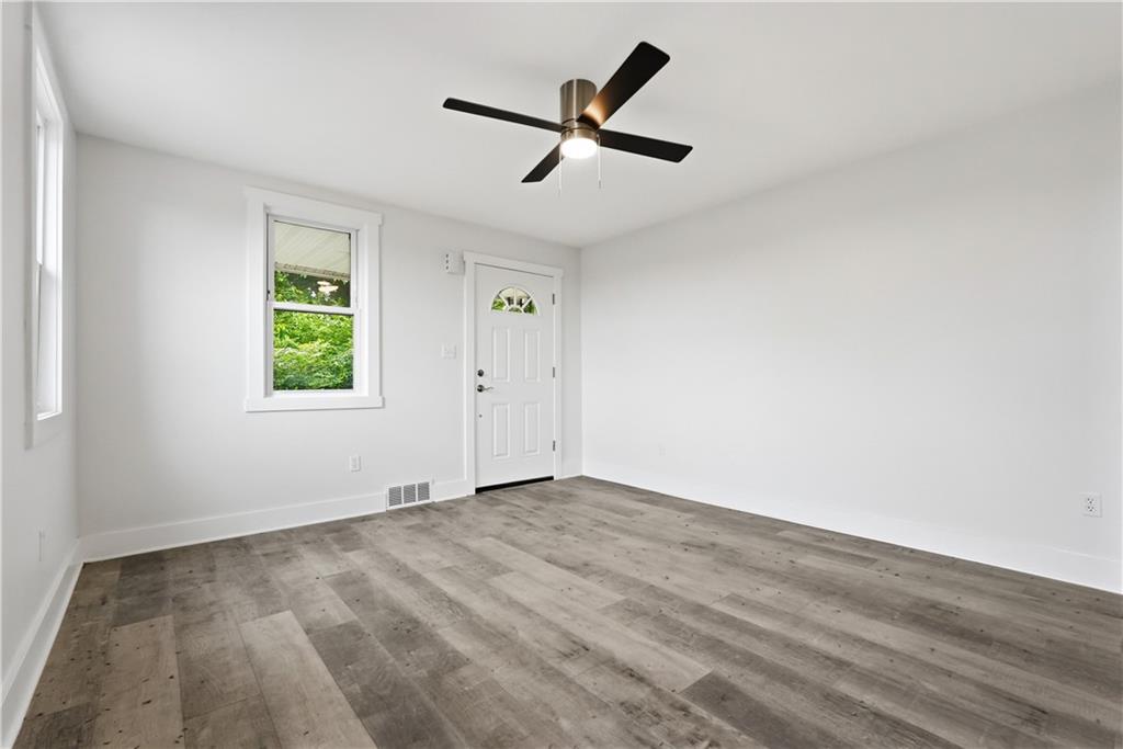 480 Songo Street Pittsburgh, PA 15227 - Photo 9 of 36 wooden floor in an empty room with a window