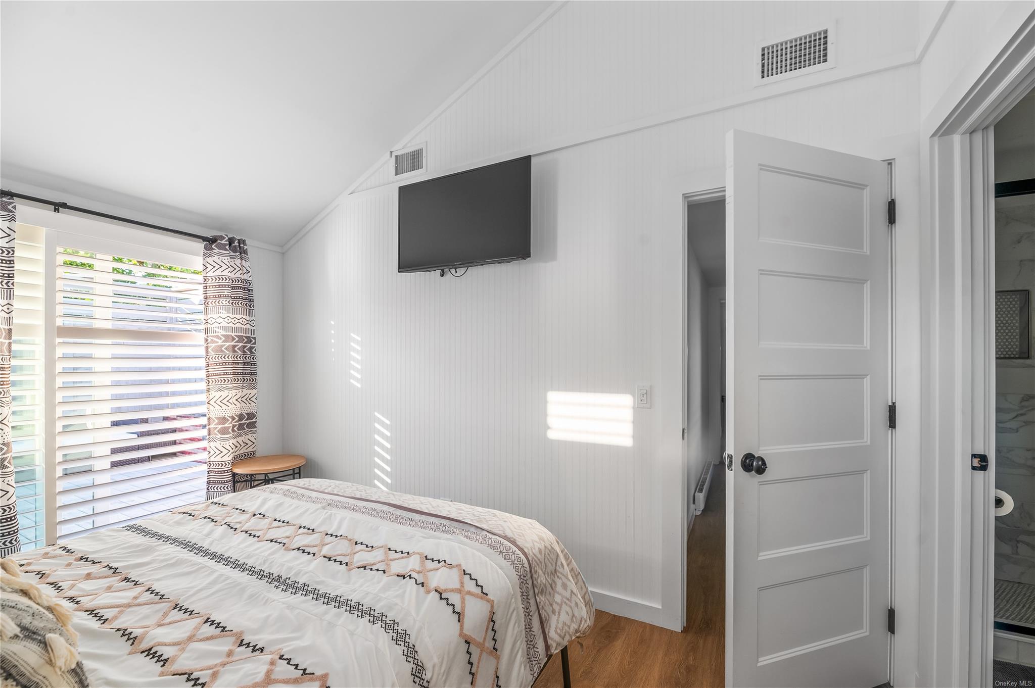 311 Wilmot Road Ocean Beach, NY 11770 - Photo 4 of 12 Bedroom with hardwood / wood-style flooring and lofted ceiling