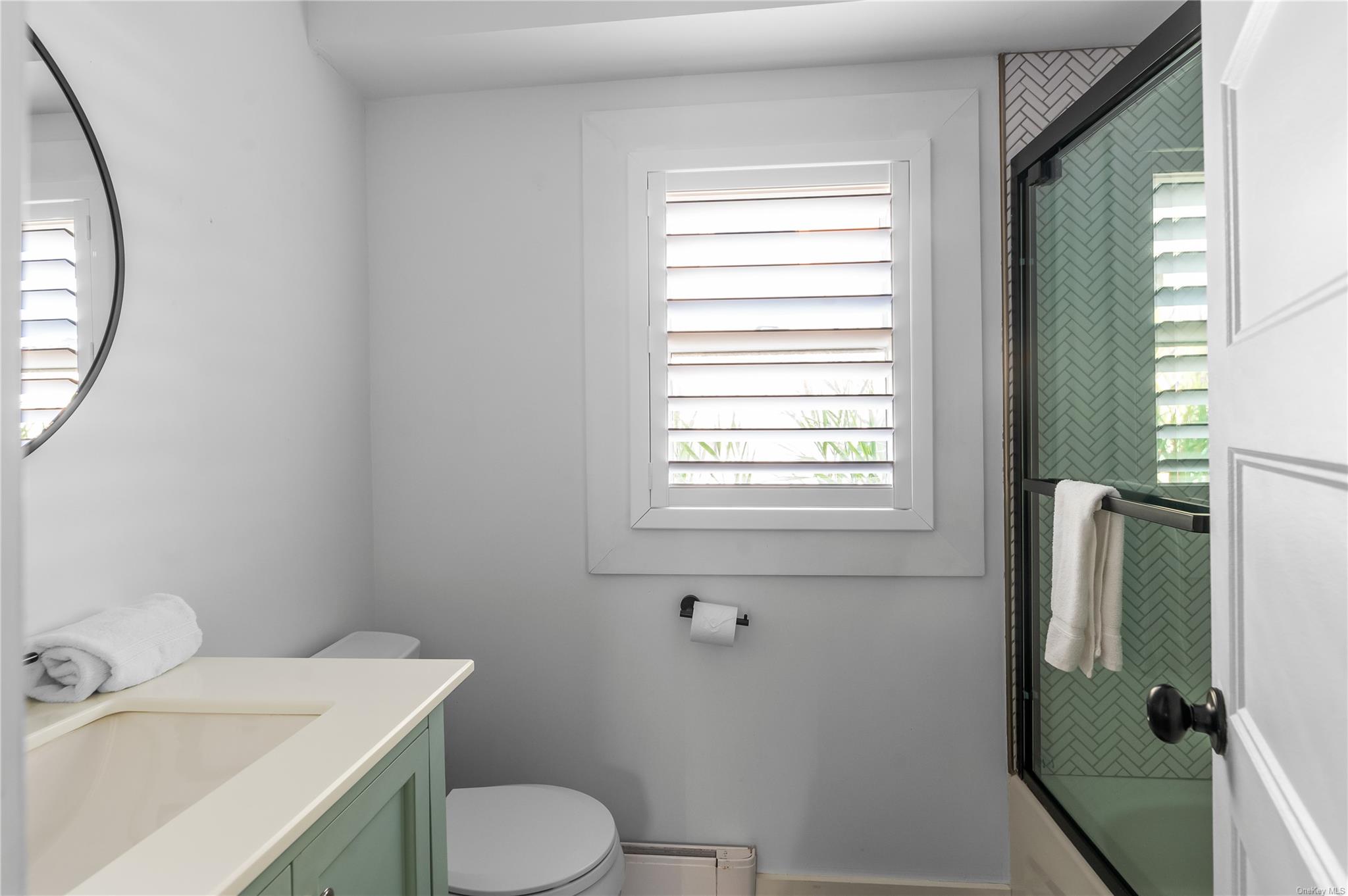 311 Wilmot Road Ocean Beach, NY 11770 - Photo 7 of 12 Full bathroom featuring vanity, shower / bath combination with glass door, and toilet