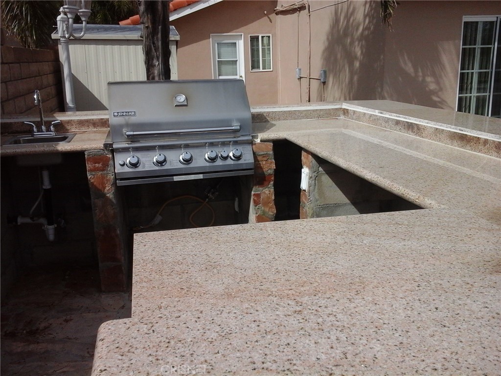 18918 Kinbrace Street Porter Ranch, CA 91326 - Photo 12 of 16 a stove top oven sitting inside of a kitchen