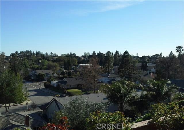 18918 Kinbrace Street Porter Ranch, CA 91326 - Photo 14 of 16 a view of a house with a street lush green forest