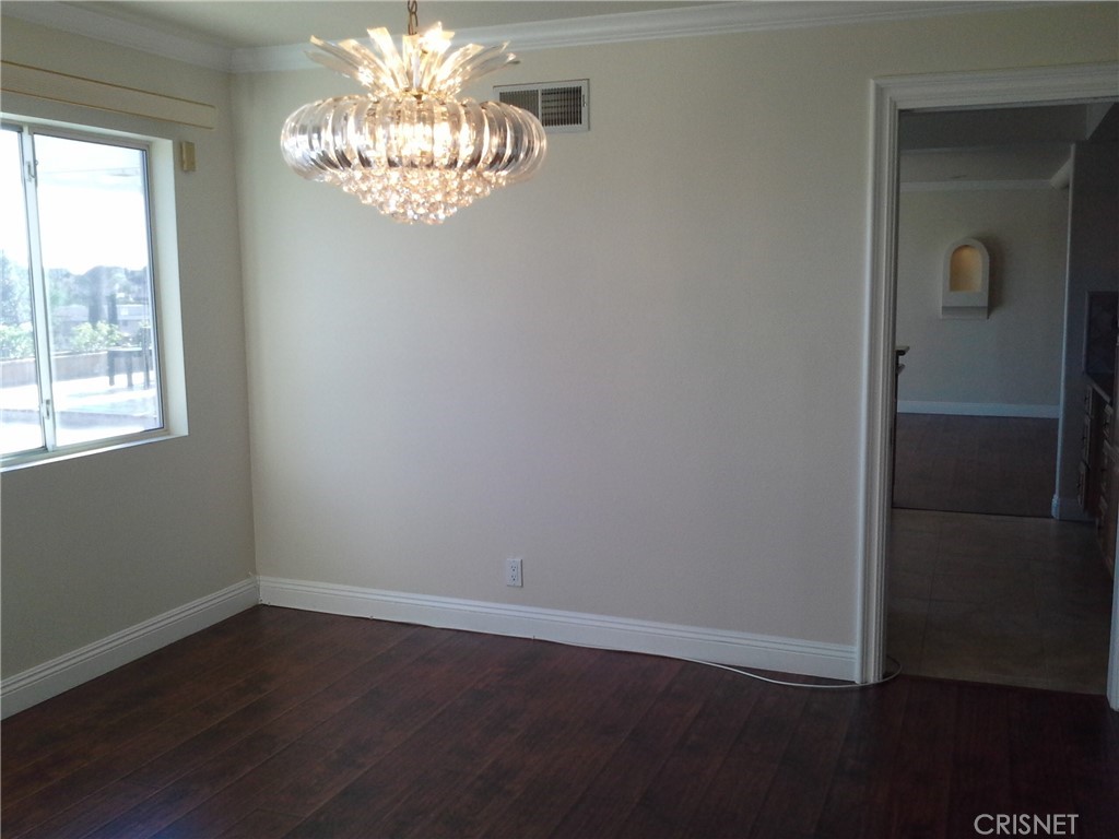 18918 Kinbrace Street Porter Ranch, CA 91326 - Photo 7 of 16 wooden floor in an empty room with a window