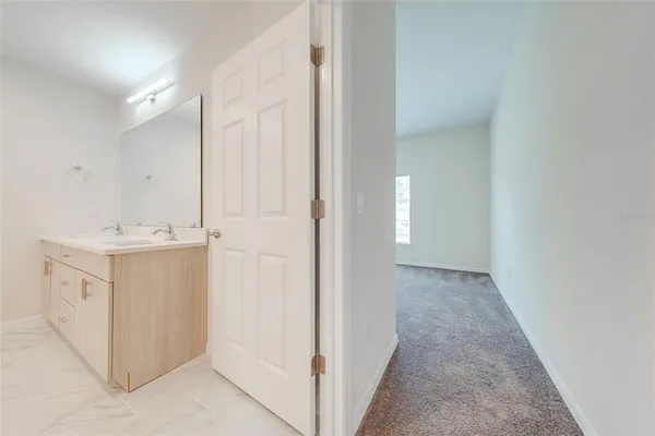 a bathroom with a granite countertop sink a toilet and a mirror