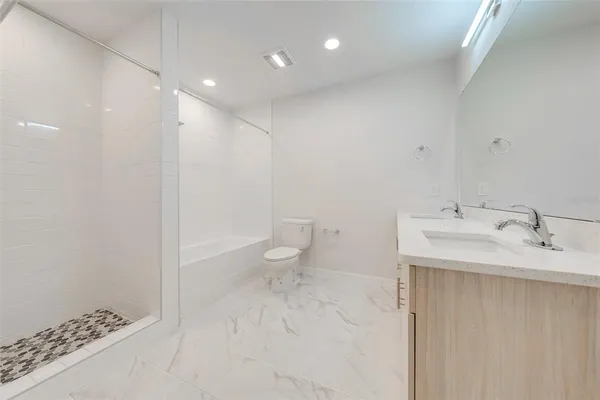 a spacious bathroom with a bathtub and a shower