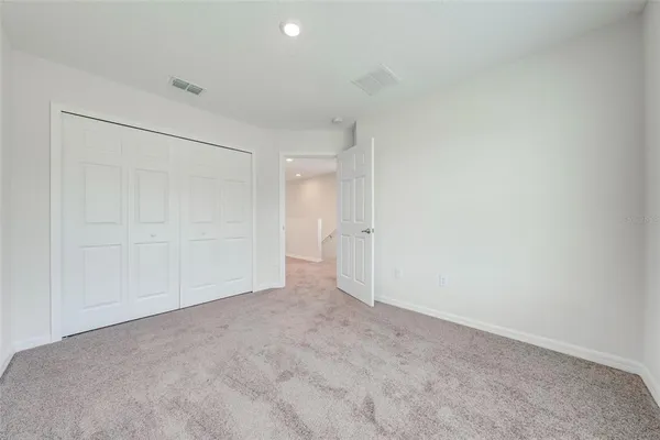 a view of an empty room and a window