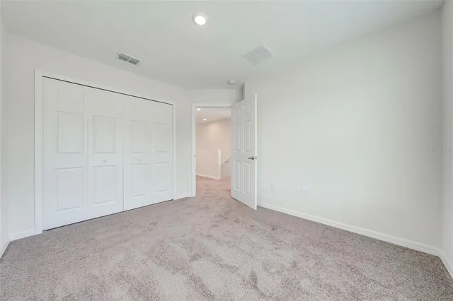 a view of an empty room and a window