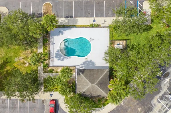 an aerial view of a house with a swimming pool and garden view