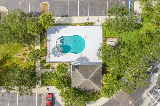 an aerial view of a house with a swimming pool and garden view