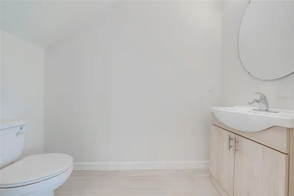 a bathroom with a sink a toilet and vanity