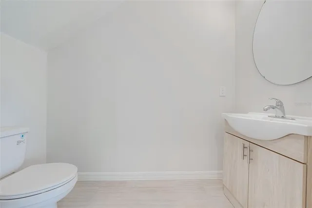 a bathroom with a sink a toilet and vanity