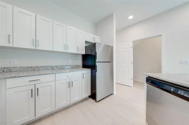 a kitchen with white cabinets