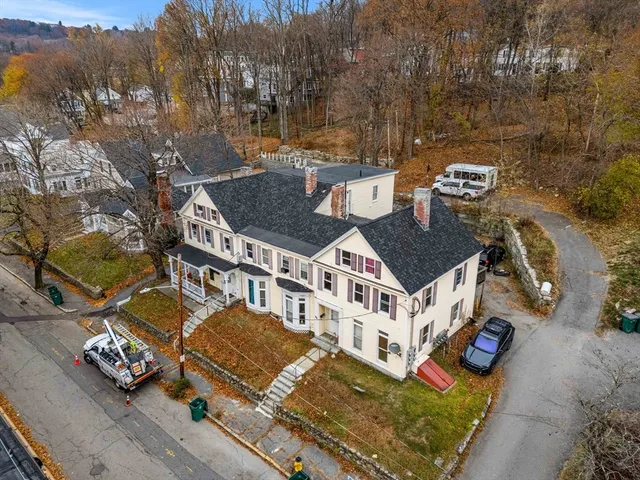 an aerial view of a house with a yard