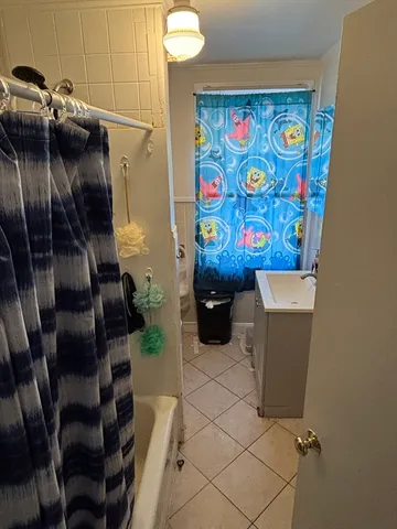 a kitchen with a stove a sink and wooden floor