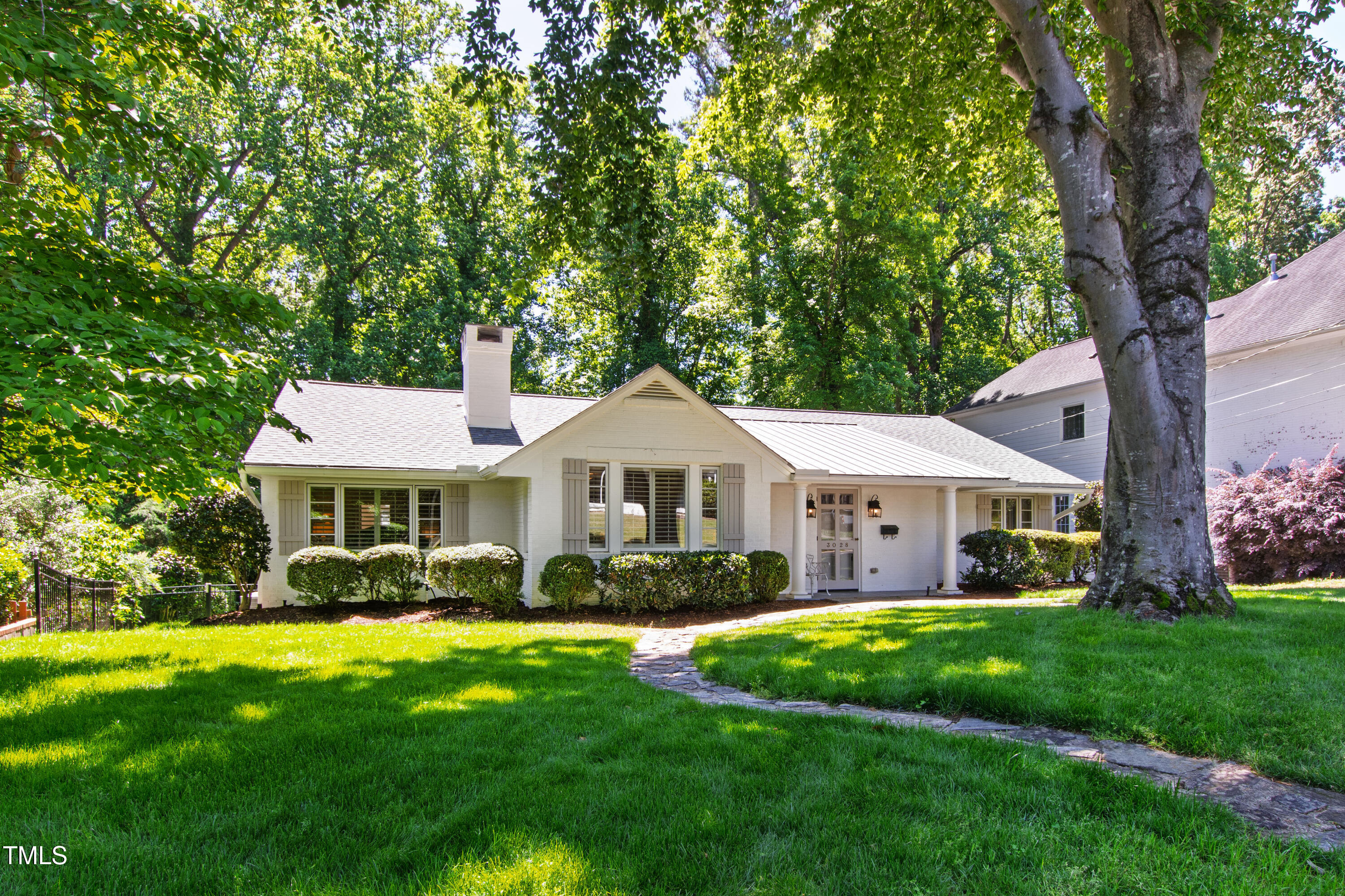 3028 Rothgeb Drive Raleigh, NC 27609 - Photo 2 of 35 a front view of a house with a garden and trees
