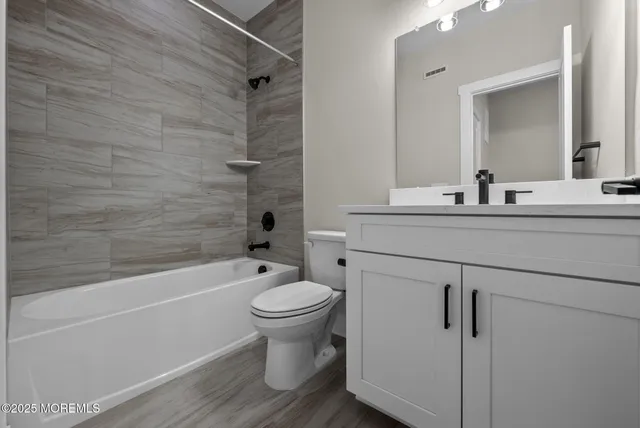 a bathroom with a sink toilet and shower