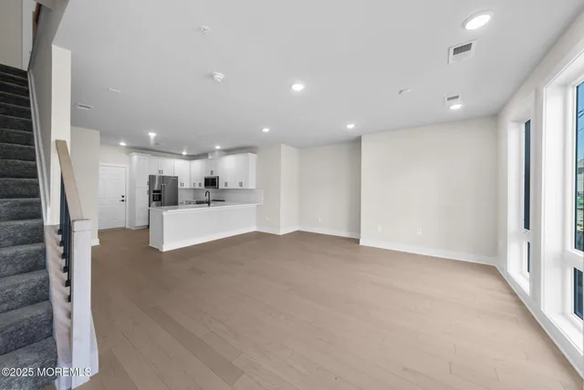 a view of kitchen with kitchen island and stainless steel appliances