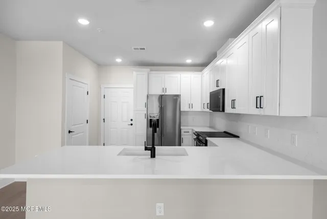 a view of kitchen with stainless steel appliances
