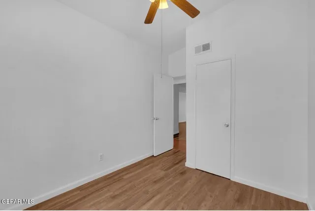 a view of room with hardwood floor and window