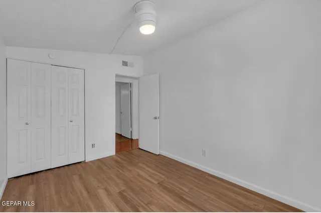 a view of an empty room and wooden floor