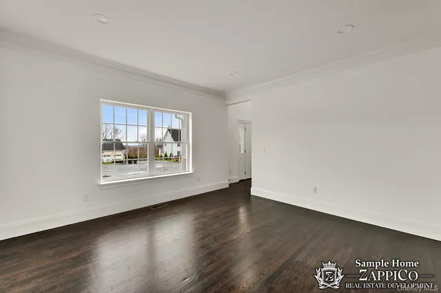 an empty room with wooden floor and window