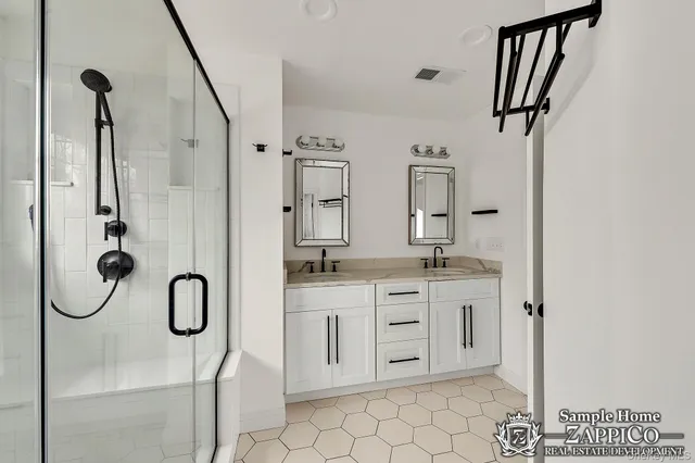 a bathroom with a double vanity sink a mirror and a shower
