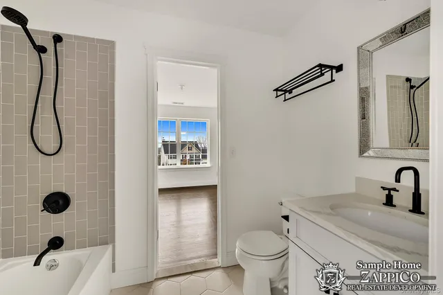 a bathroom with a granite countertop sink a toilet and a shower
