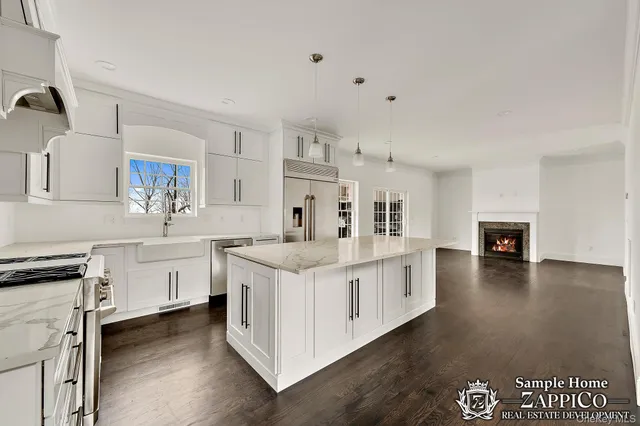 a kitchen with white cabinets and sink