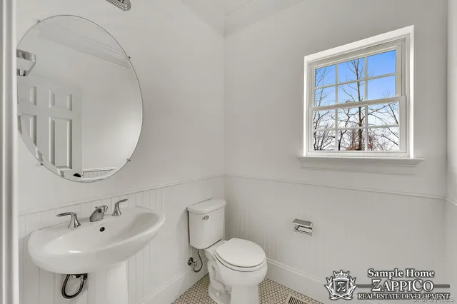 a bathroom with a sink a toilet and mirror