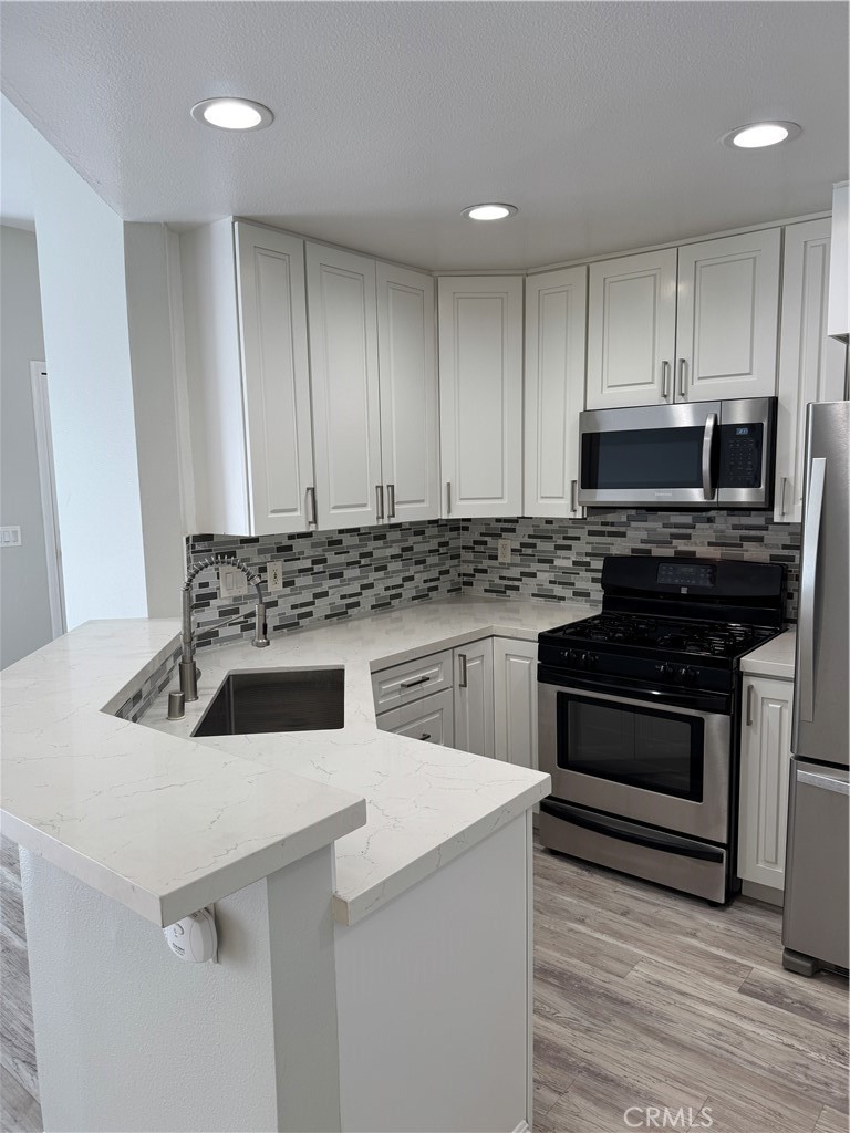 1730 Sinaloa Road Simi Valley, CA 93065 - Photo 11 of 38 a kitchen with a stove and a microwave