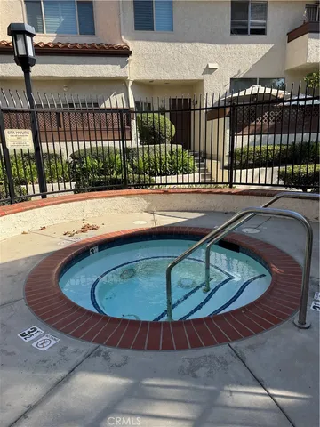 a view of a tennis ground with large trees