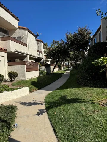 a view of a garden with large trees