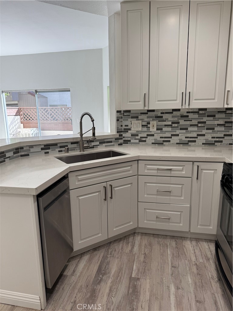 1730 Sinaloa Road Simi Valley, CA 93065 - Photo 5 of 38 a kitchen with white cabinets and sink