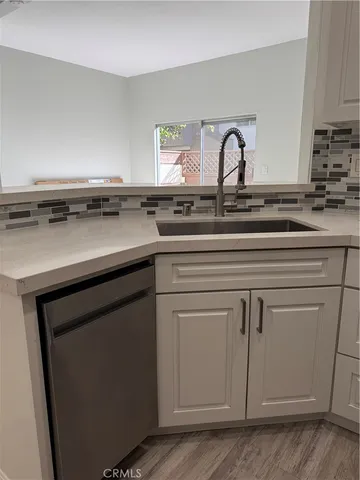 a kitchen with cabinets appliances a sink and a counter top