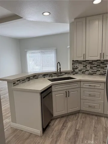 a kitchen with sink cabinets and window