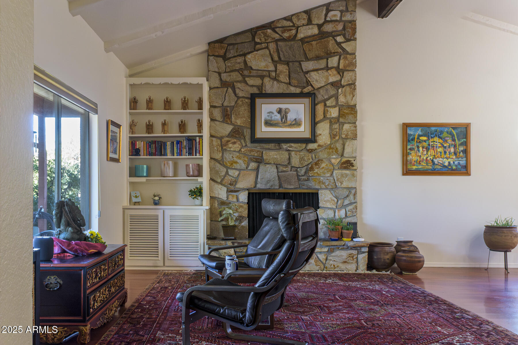 120 Indian Ruin Road Sedona, AZ 86351 - Photo 15 of 46 a living room with furniture and a fireplace