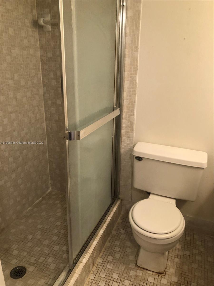 250 Gate Road, Unit 153 Hollywood, FL 33024 - Photo 14 of 19 a white toilet sitting next to a shower