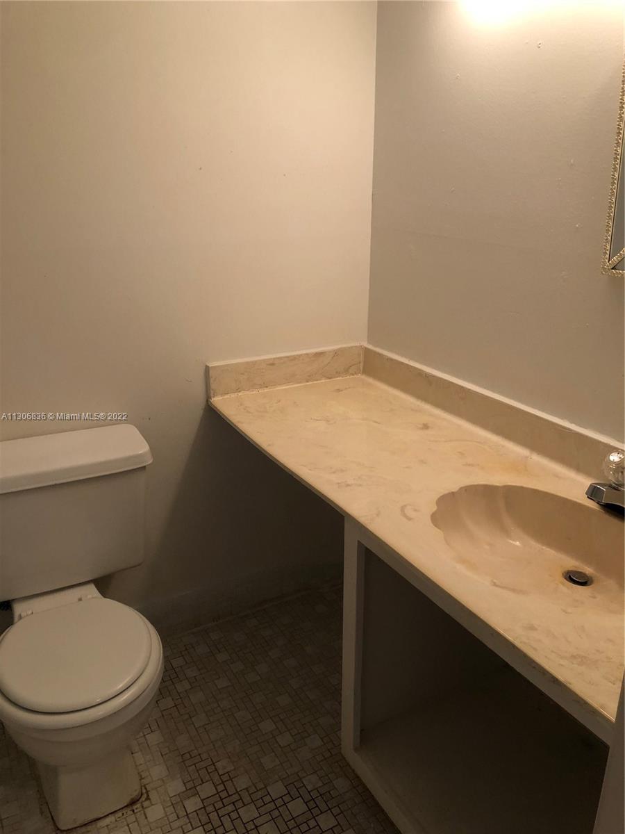 250 Gate Road, Unit 153 Hollywood, FL 33024 - Photo 15 of 19 a bathroom with a sink and a toilet