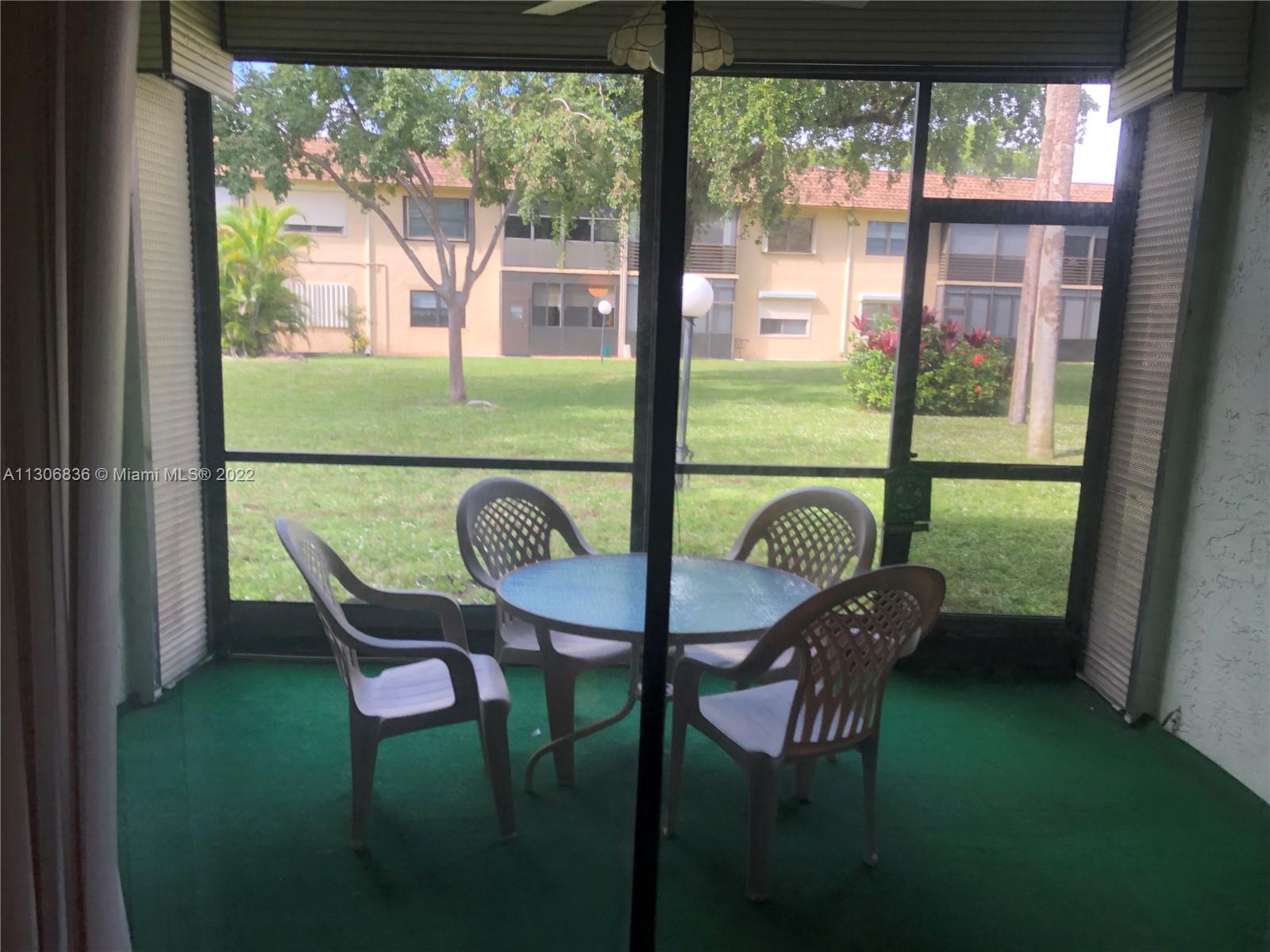 250 Gate Road, Unit 153 Hollywood, FL 33024 - Photo 18 of 19 a view of a dining room with furniture window and outside view
