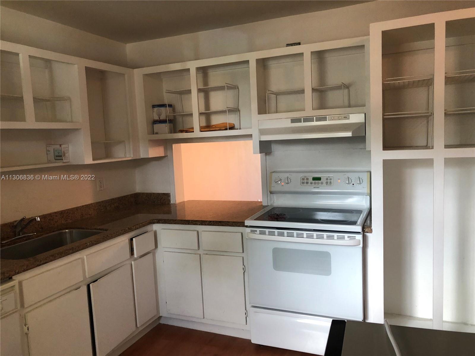 250 Gate Road, Unit 153 Hollywood, FL 33024 - Photo 6 of 19 a kitchen with stainless steel appliances granite countertop a sink and a stove