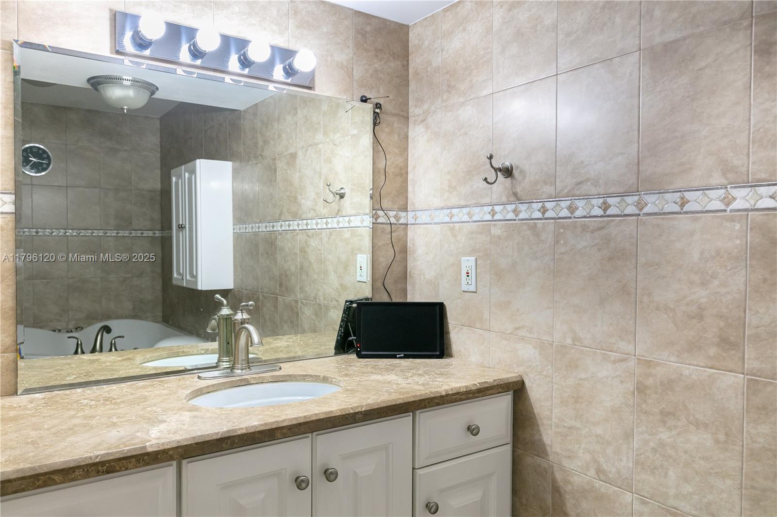 2101 South Ocean Drive, Unit 606 Hollywood, FL 33019 - Photo 14 of 58 a bathroom with a sink and a mirror